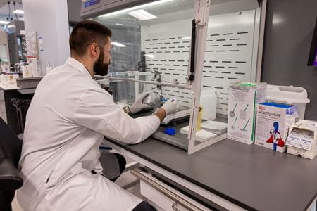 A scientist working at a research lab bench