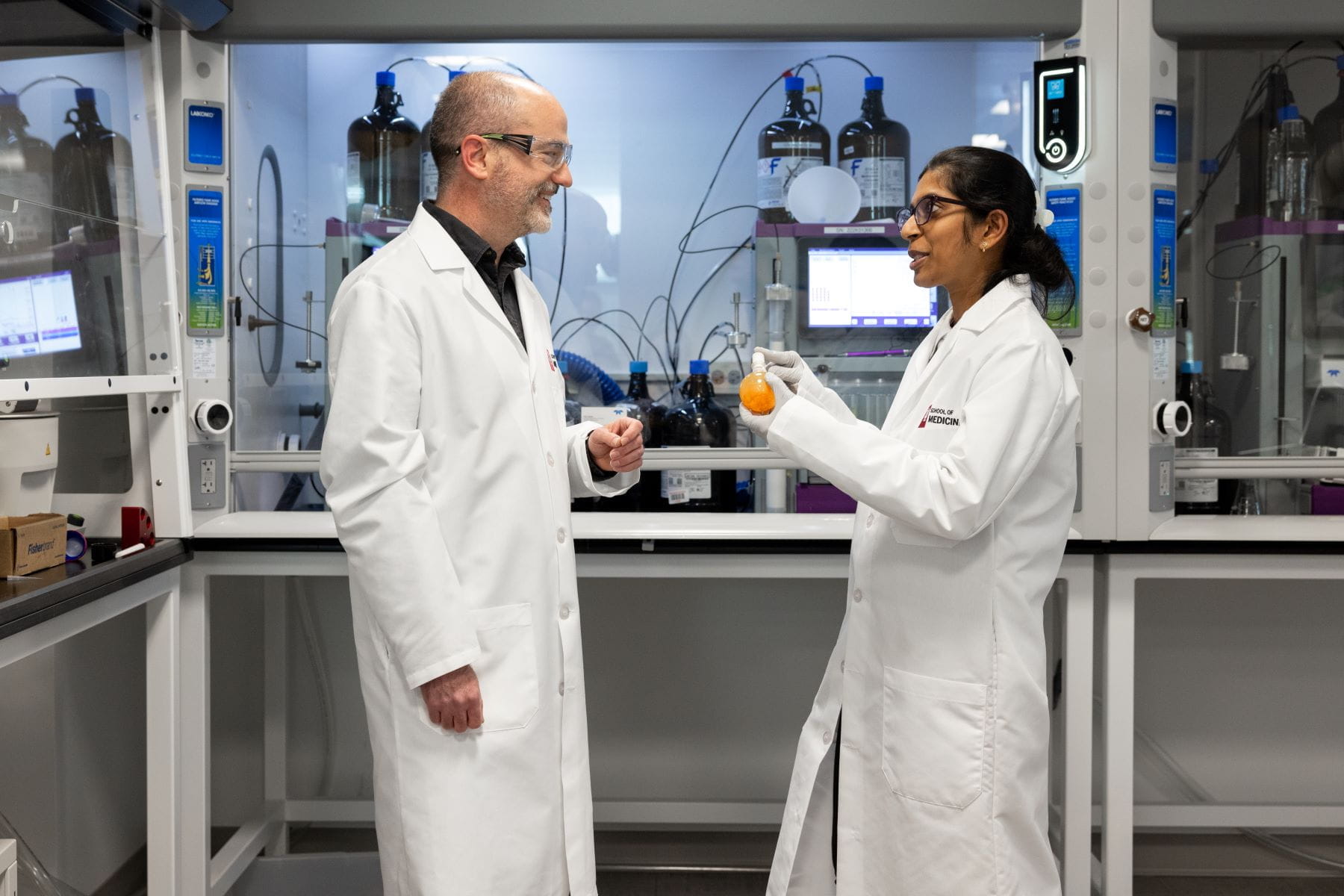 Tim Richardson and Chetna Jadala talk in a research lab