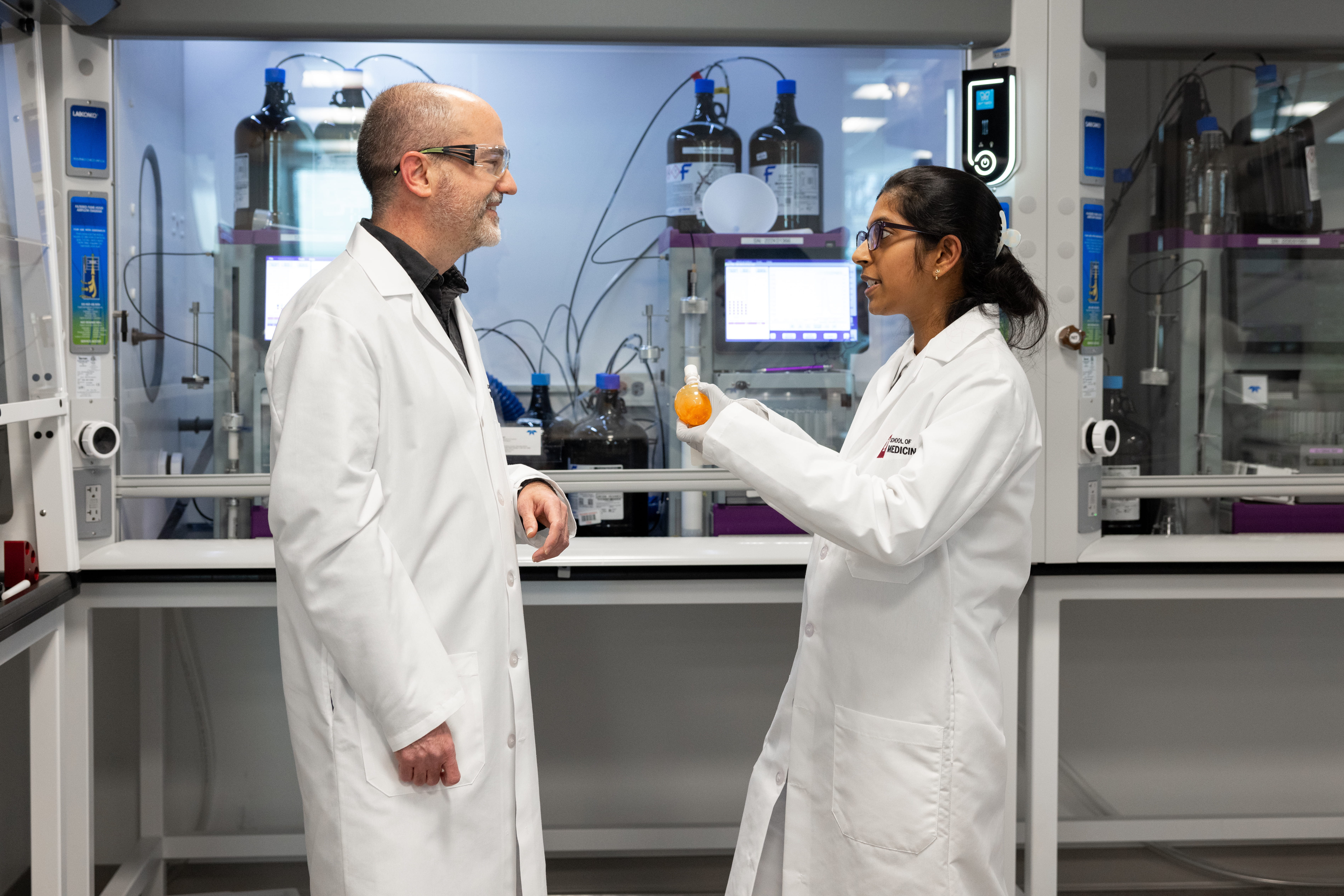 Tim Richardson and Chetna Jadala talk in a research lab