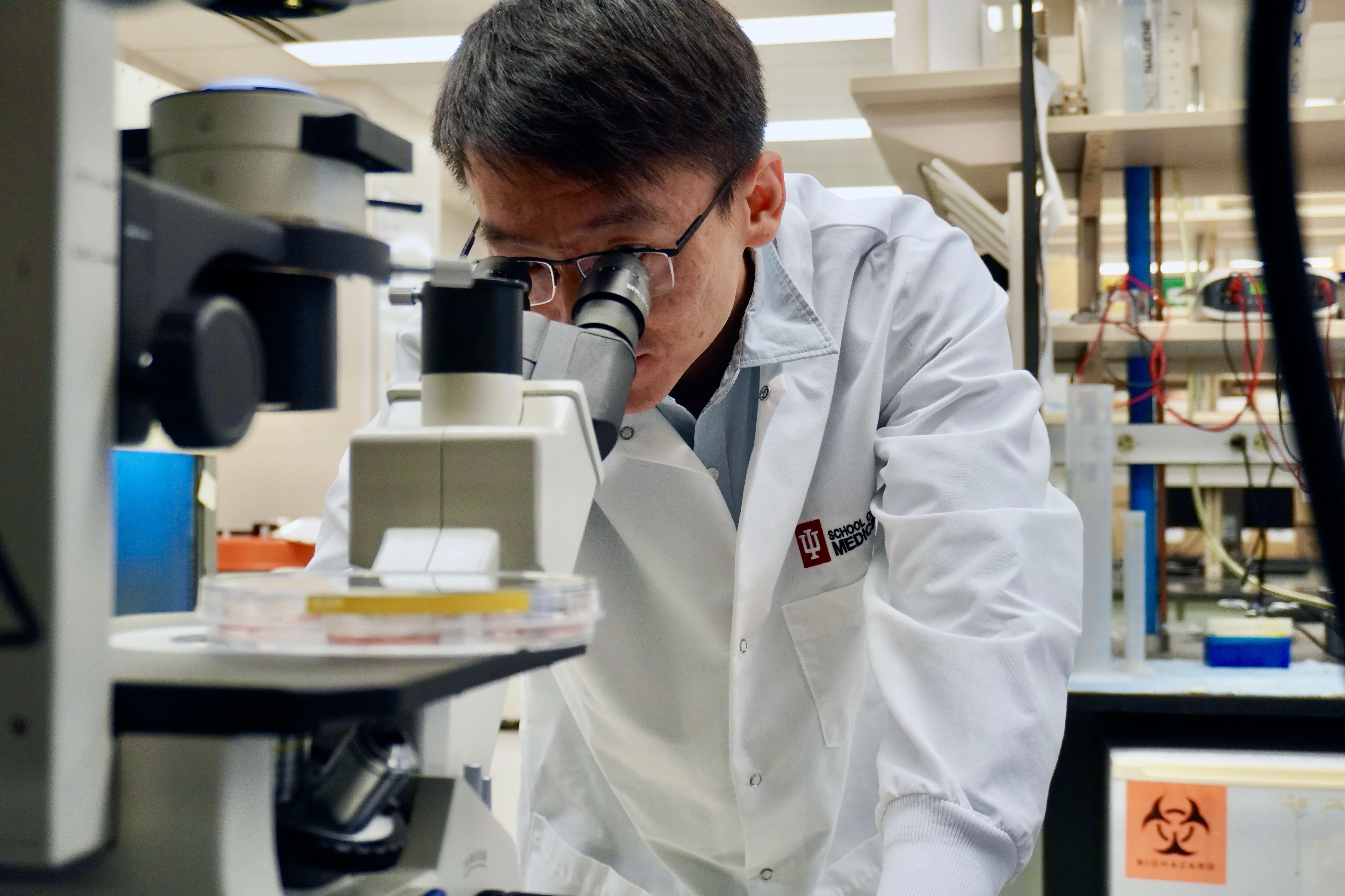  Ji Zhang looks through microscope 
