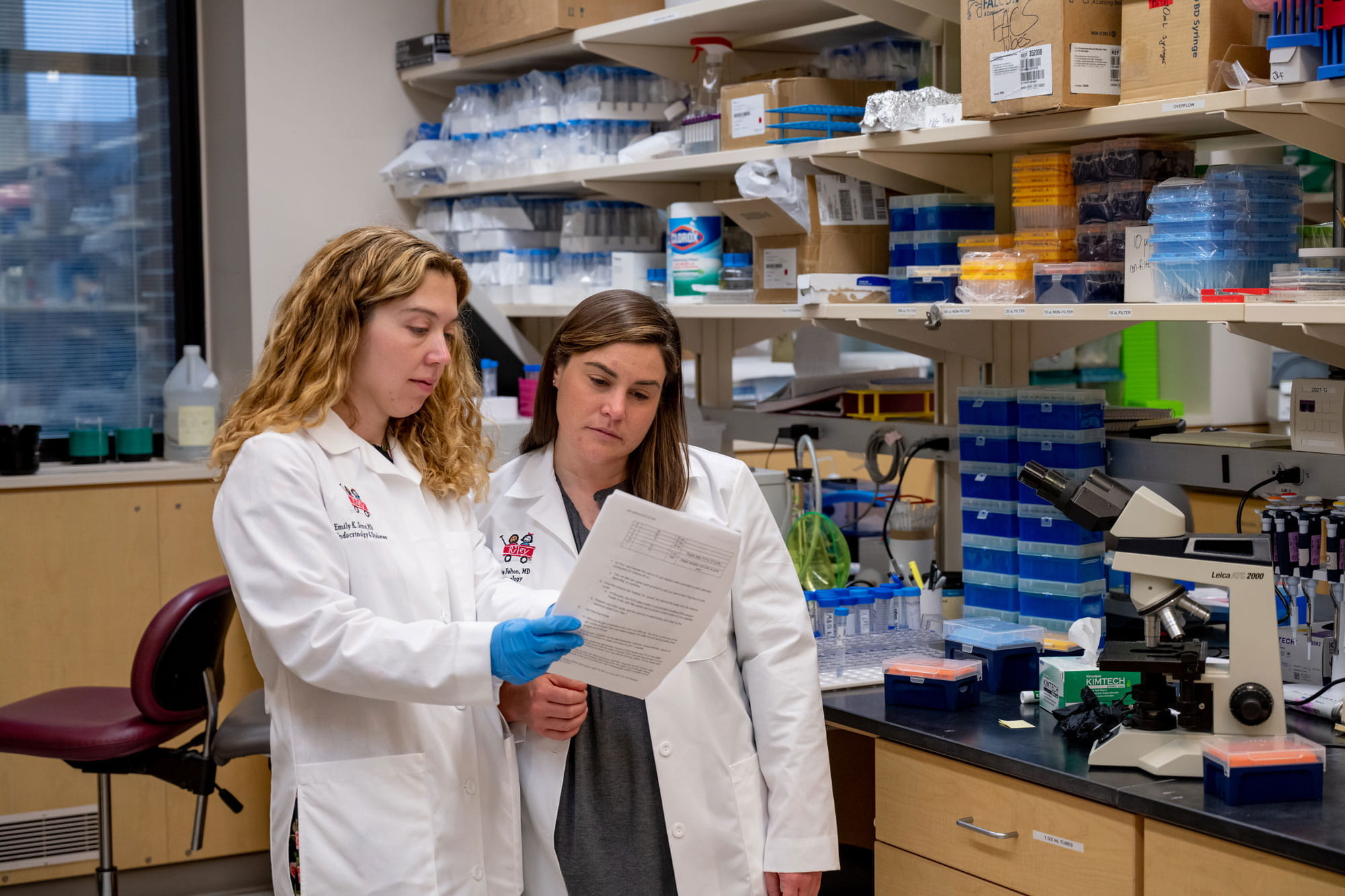 Emily Sims and Jamie Felton review a document in their research lab