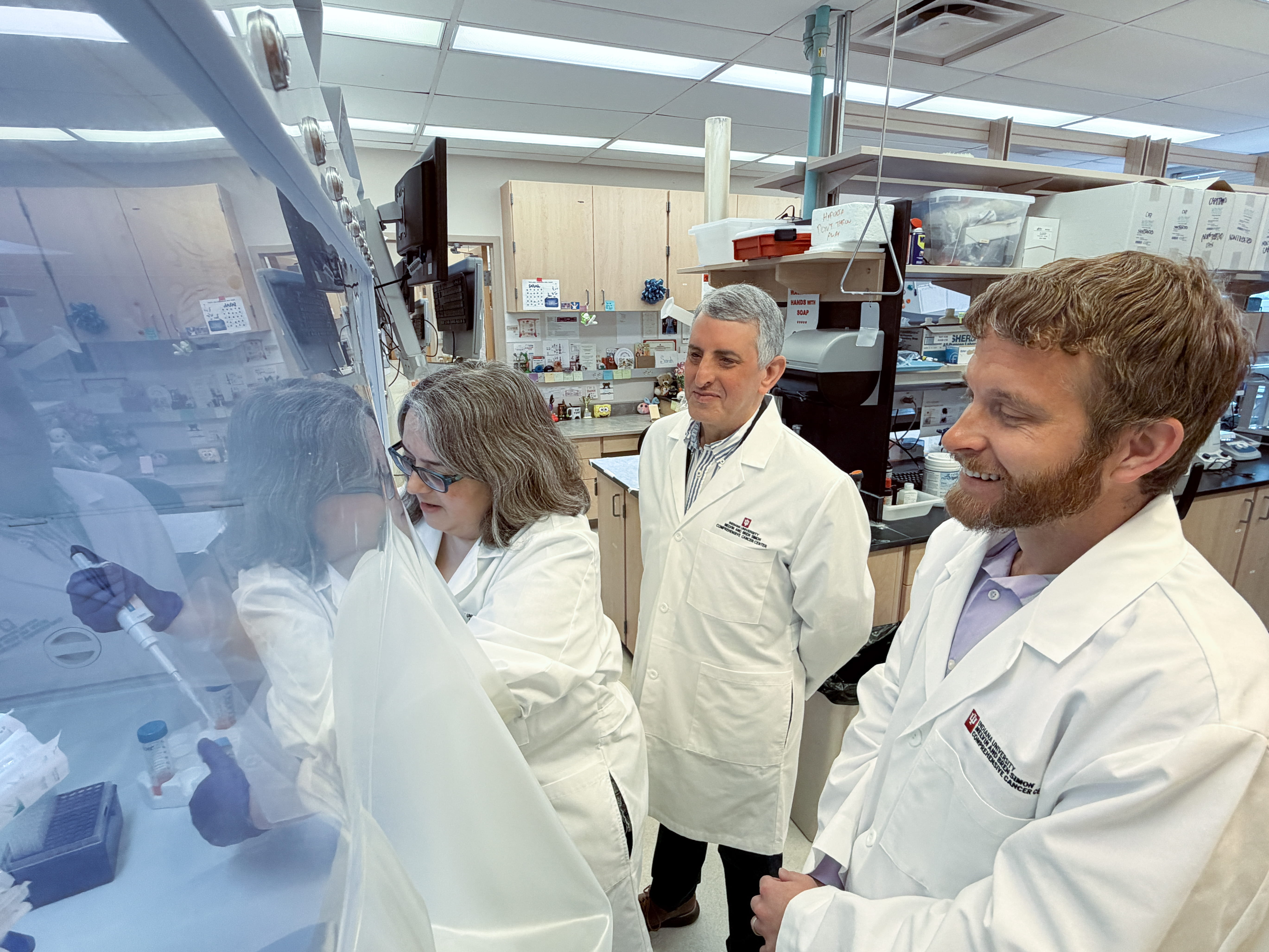 Three researchers use a lab. 
