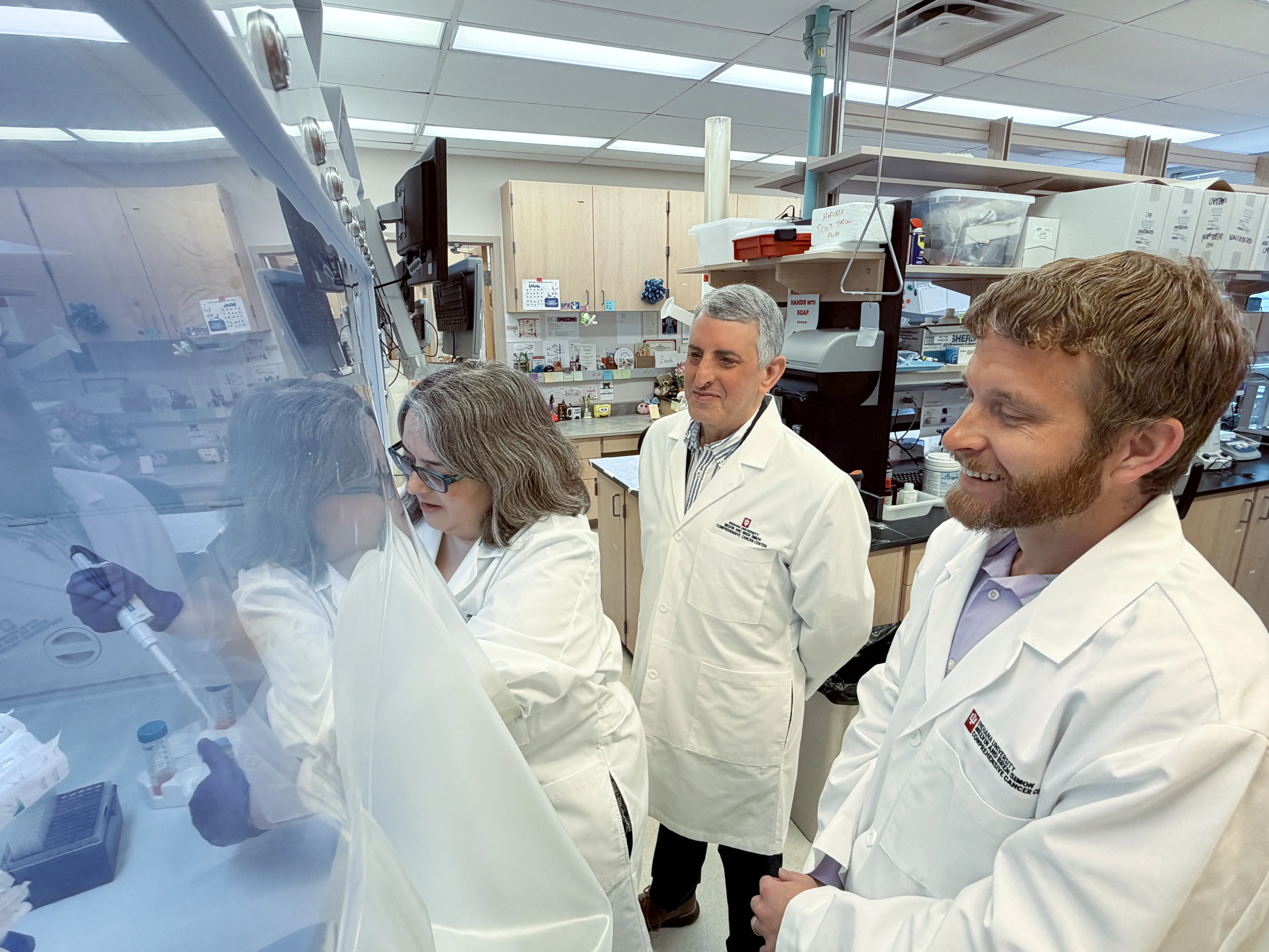 Three researchers use a lab. 