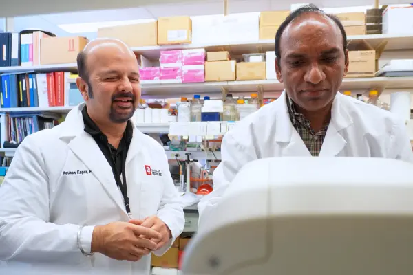 Two men work in a lab