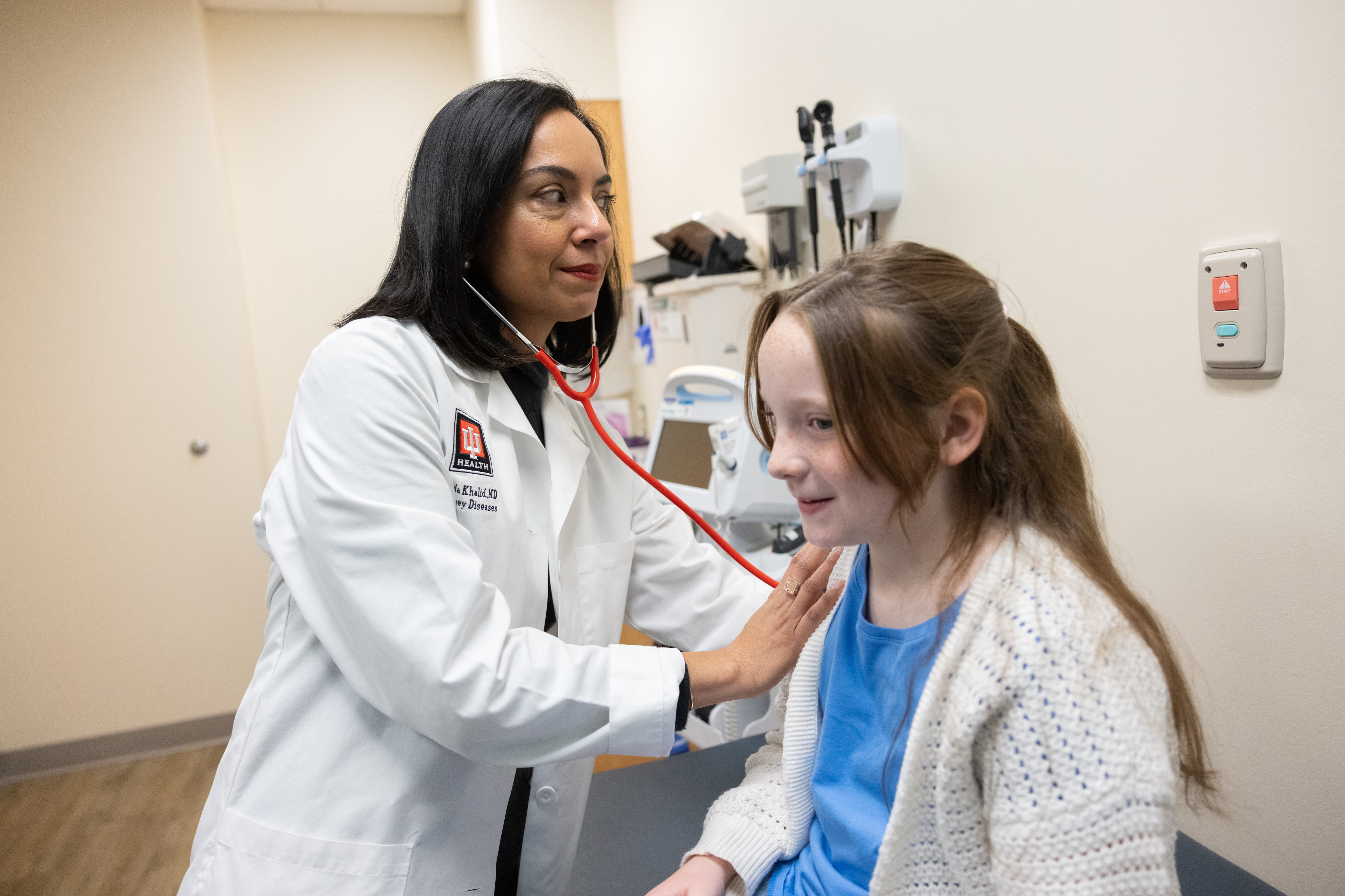 A doctor examines a child. 