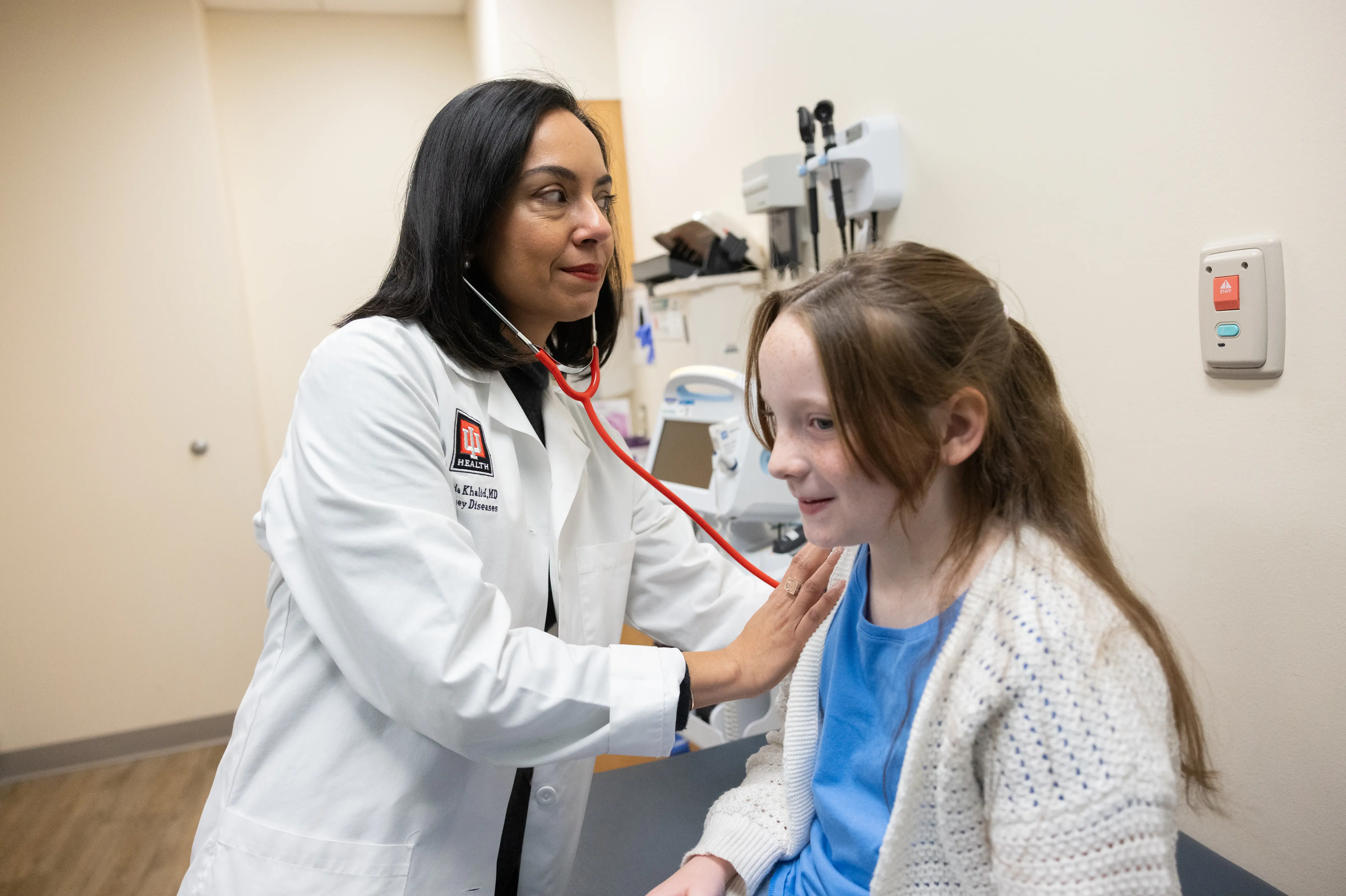 A doctor examines a child. 