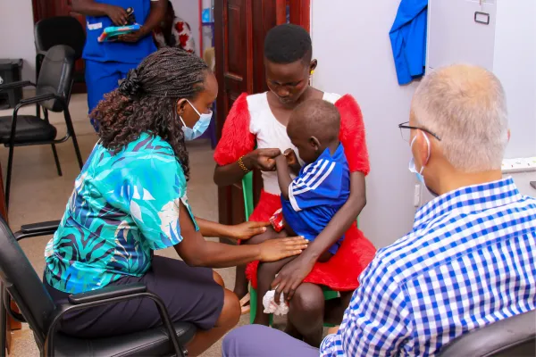 Two doctors examine a child in Africa