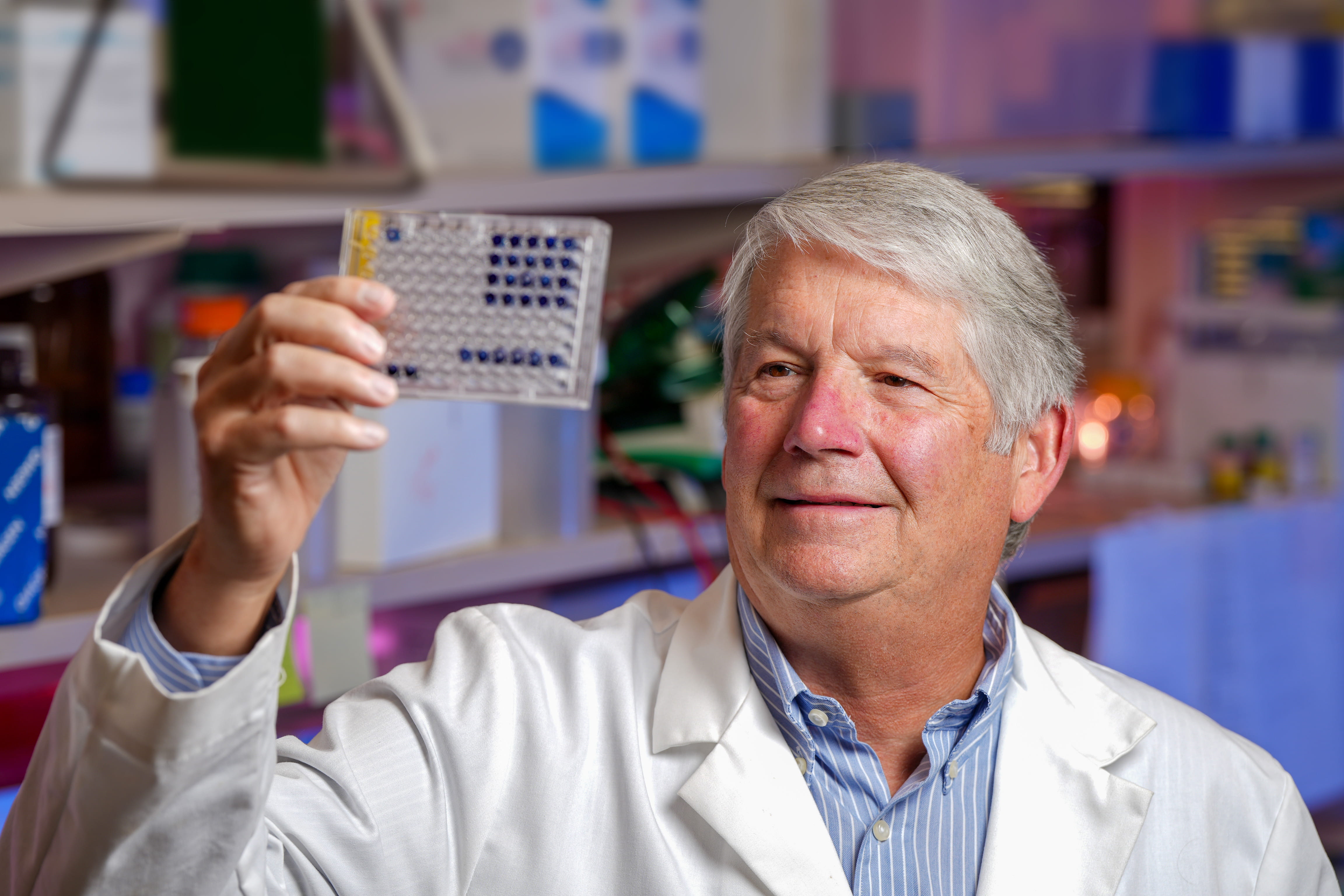Mark Kelly looking at container in lab