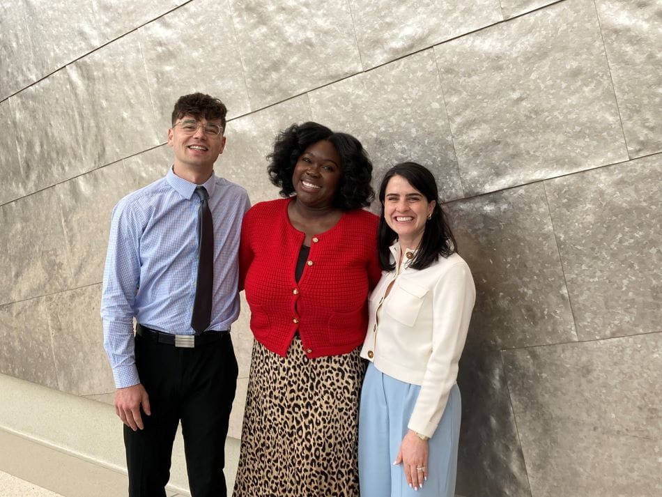 Photo of three OB-GYN residents standing and professionally dressed.