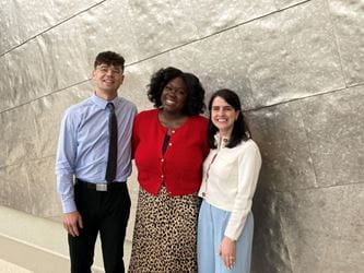 Photo of three OB-GYN residents standing and professionally dressed.