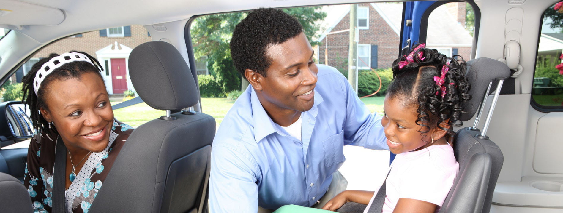 Mom and Dad with child in booster