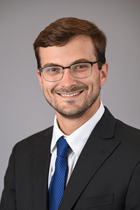 Harrison Thompson | Photo by Tim Yates, IU School of Medicine Harrison Thompson, man in suit smiling at camera