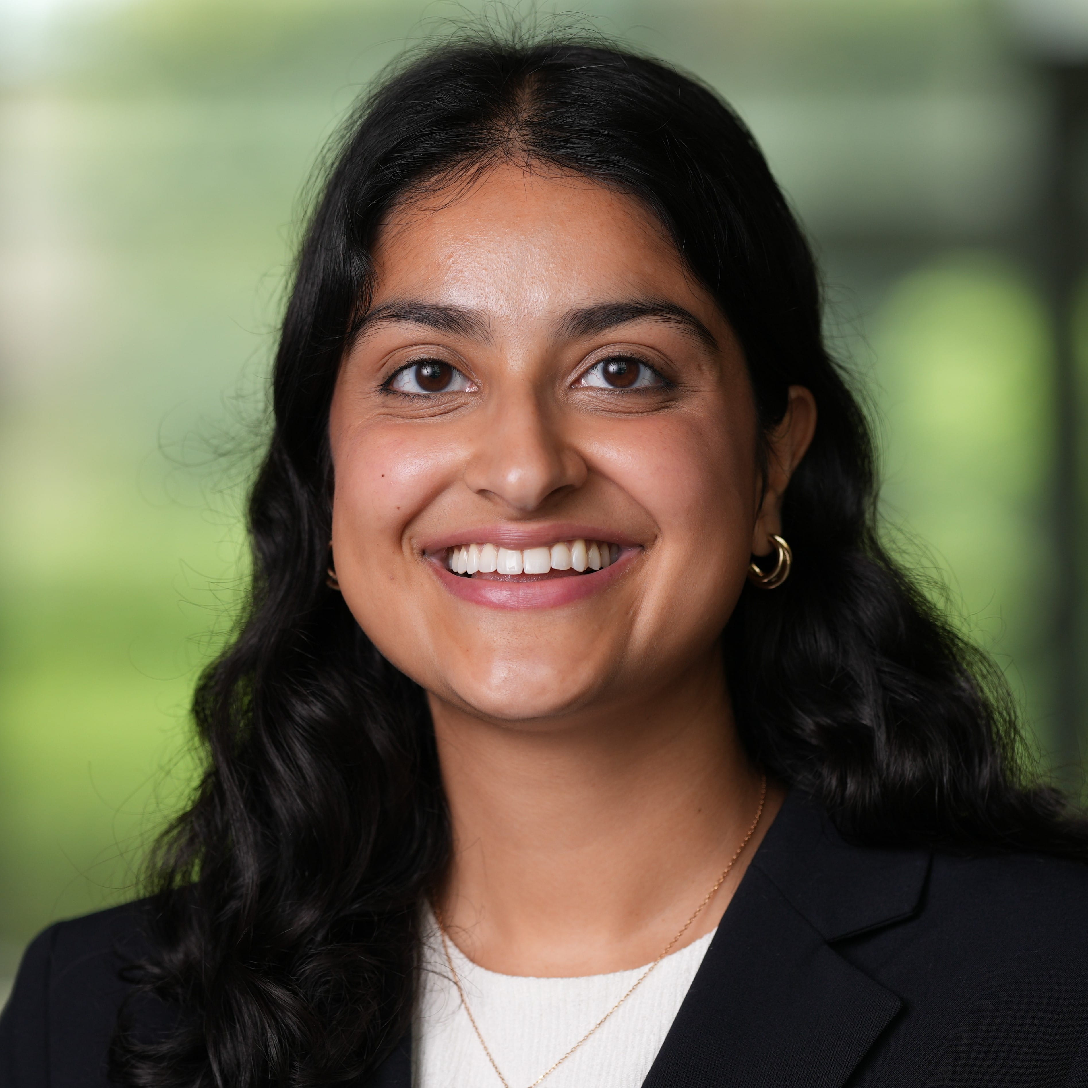 Anu Sharma smiling at camera