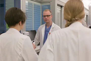 Physician and fellows discuss child protection. 