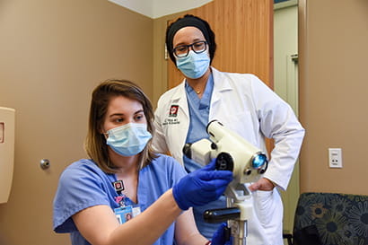 a resident and a faculty member work together on a research project