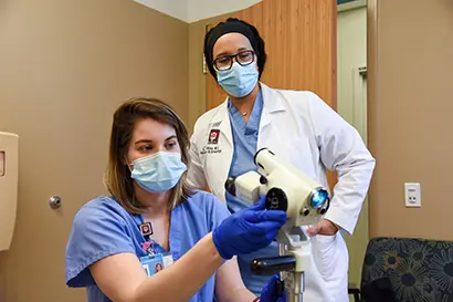 a resident and a faculty member work together on a research project