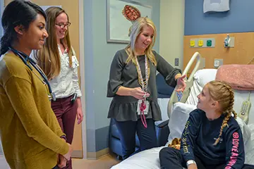 Residents visit patient while in the Pediatrics Residency Curriculum