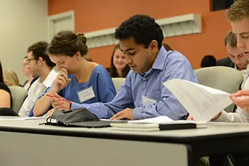 Group shot of students reviewing coursework