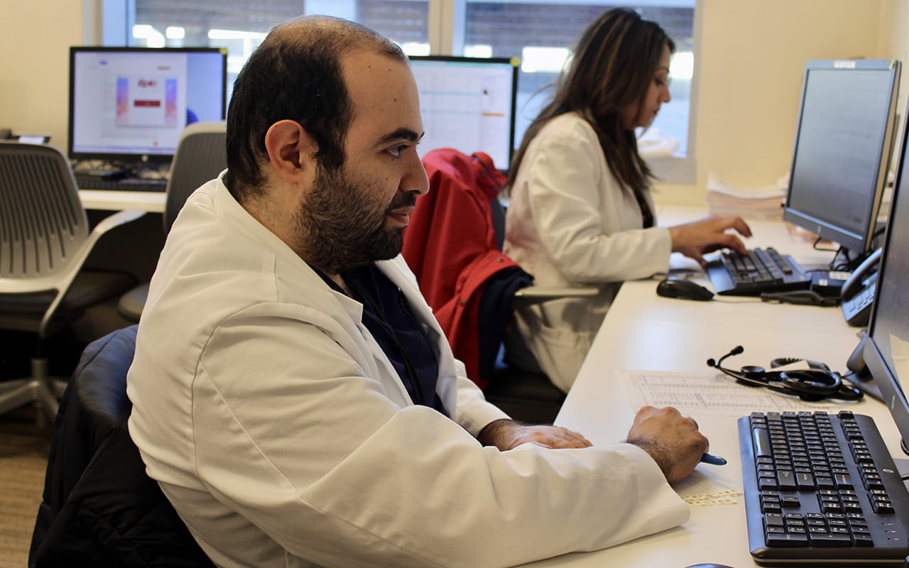  Dr Hamed Chehab (foreground) and Dr Saira Butt (background) using computers to study
