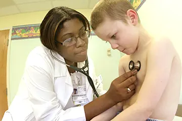 A physician checking a patient's lings
