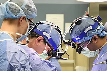 three surgeons at work in the OR