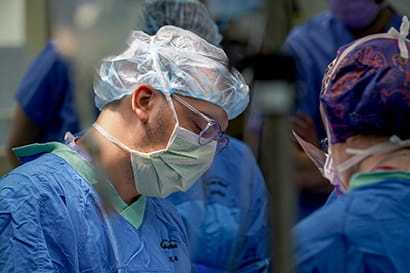 a surgeon looks down at his work