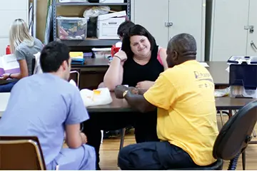 students speak with a patient at the outreach clinic