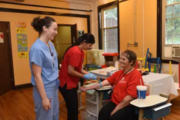 a patient gets her blood pressure taken at the clinic