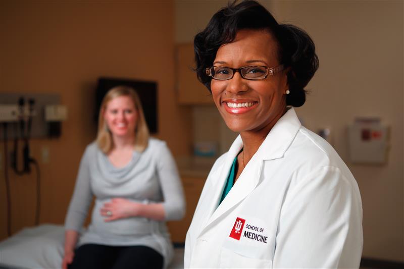 Brownsyne Tucker Edmonds and a pregnant patient in the clinic