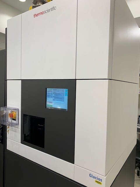 a large enclosed microscope with a digital screen on the front. the bottom corner reads "Glacios"