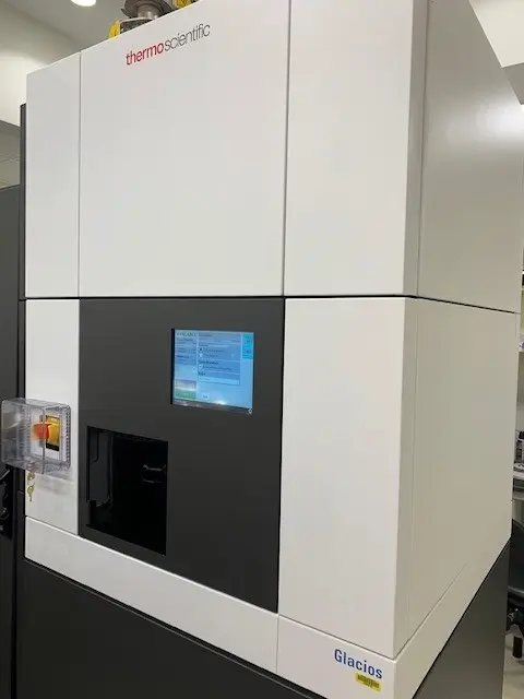 a large enclosed microscope with a digital screen on the front. the bottom corner reads "Glacios"