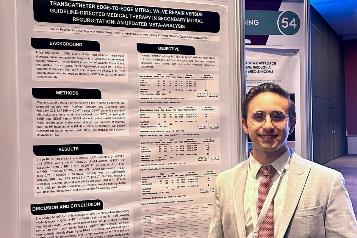 Daniel stands with his poster at the conference