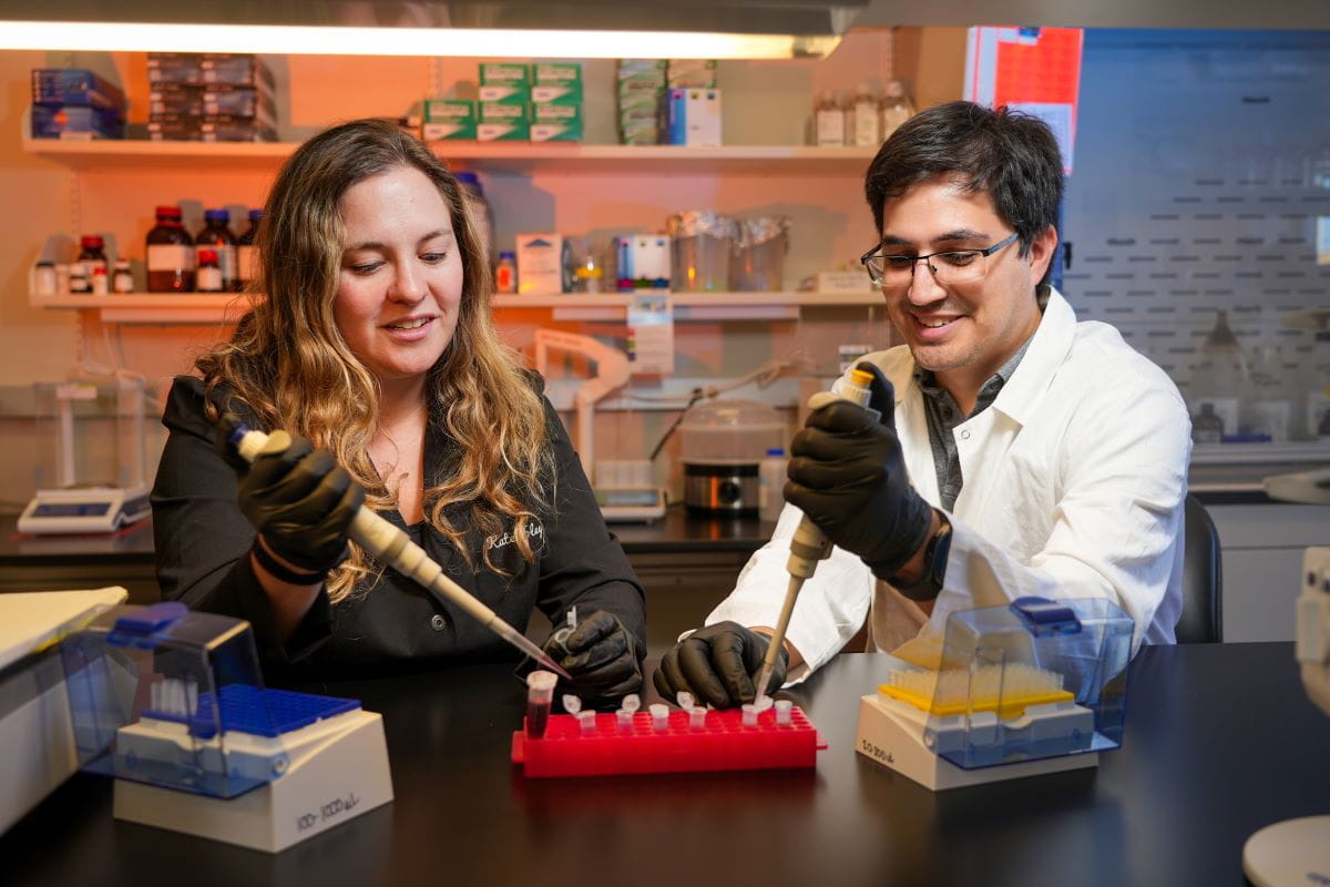 two researchers prepare samples together in the lab