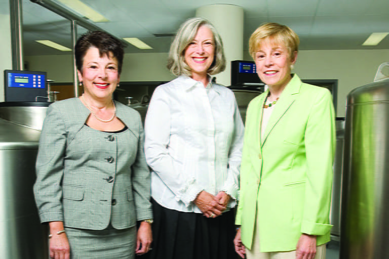 Storniolo, Rufenbarger and Clare stand in front of biobank storage