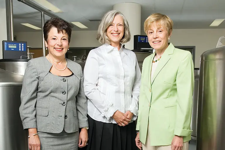 Storniolo, Rufenbarger and Clare stand in front of biobank storage