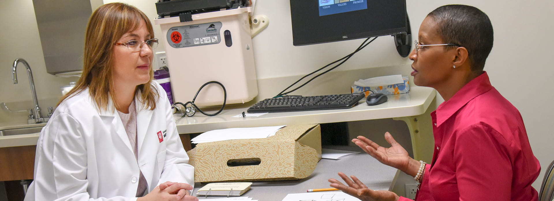 Liana Apostolova listens to a patient from her research study