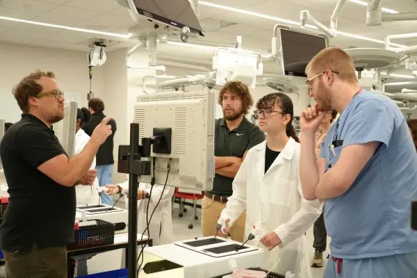 Indiana School for the Deaf student practices a surgical skills exercise as an interpreter provides communication access. | Photo courtesy Cassie Needy