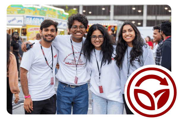A group of college students embrace and smile as they look into the camera.