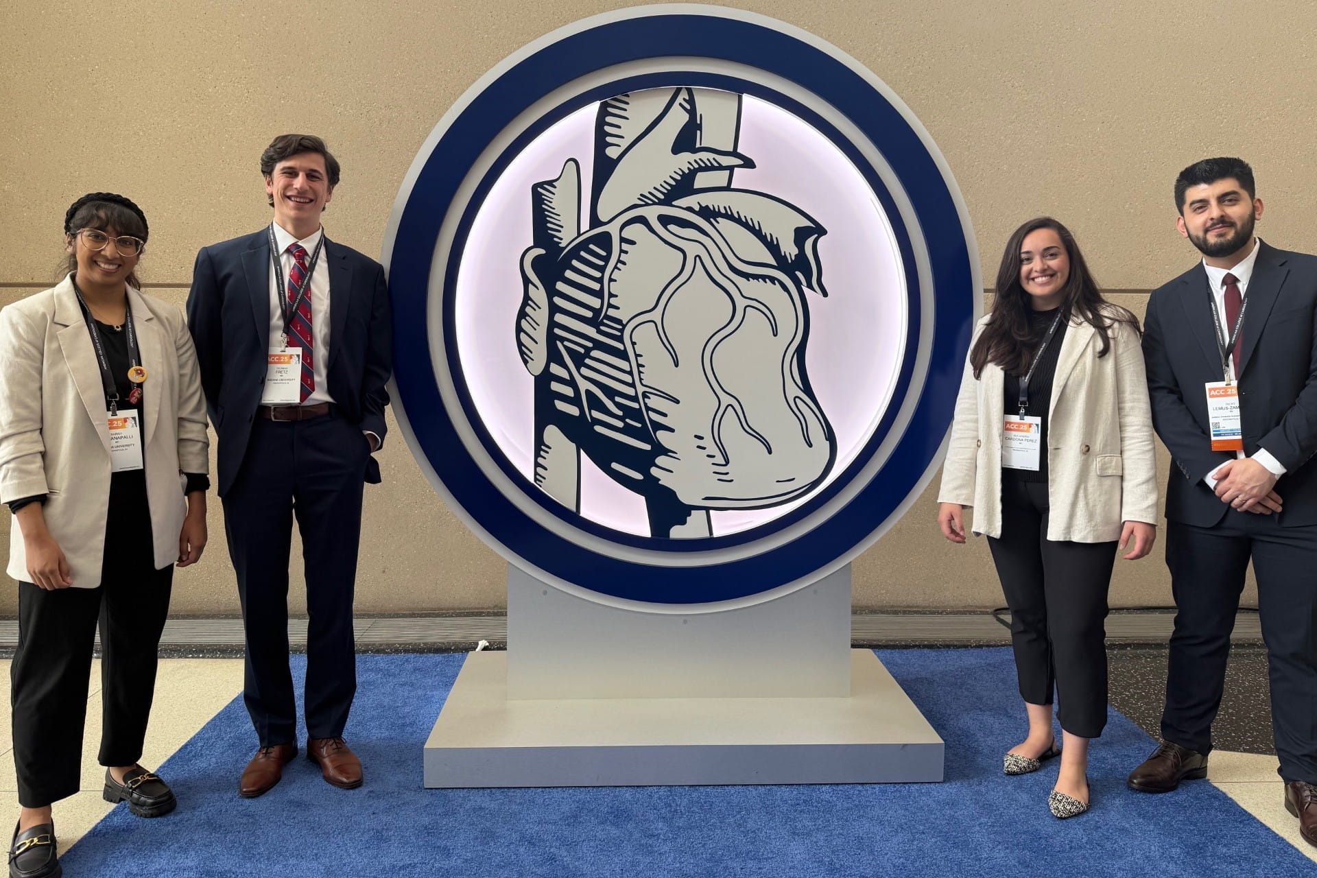 4 residents posing with research conference logo