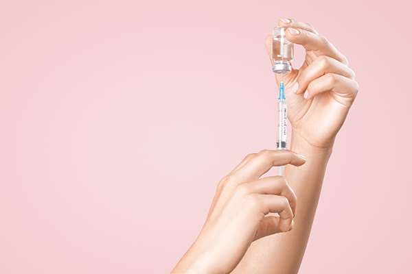 A vaccination syringe getting prepared.
